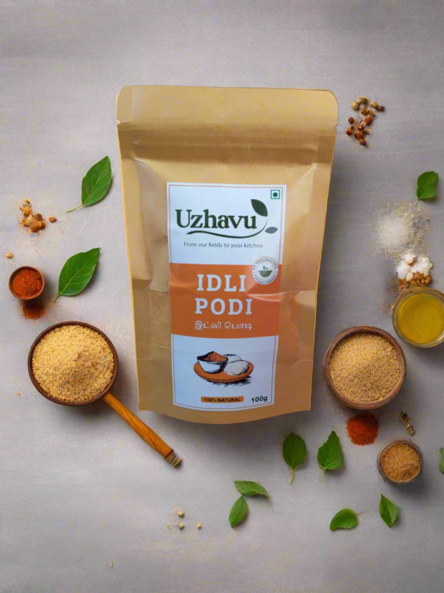 Uzhavu Idli Podi packaging on a black background